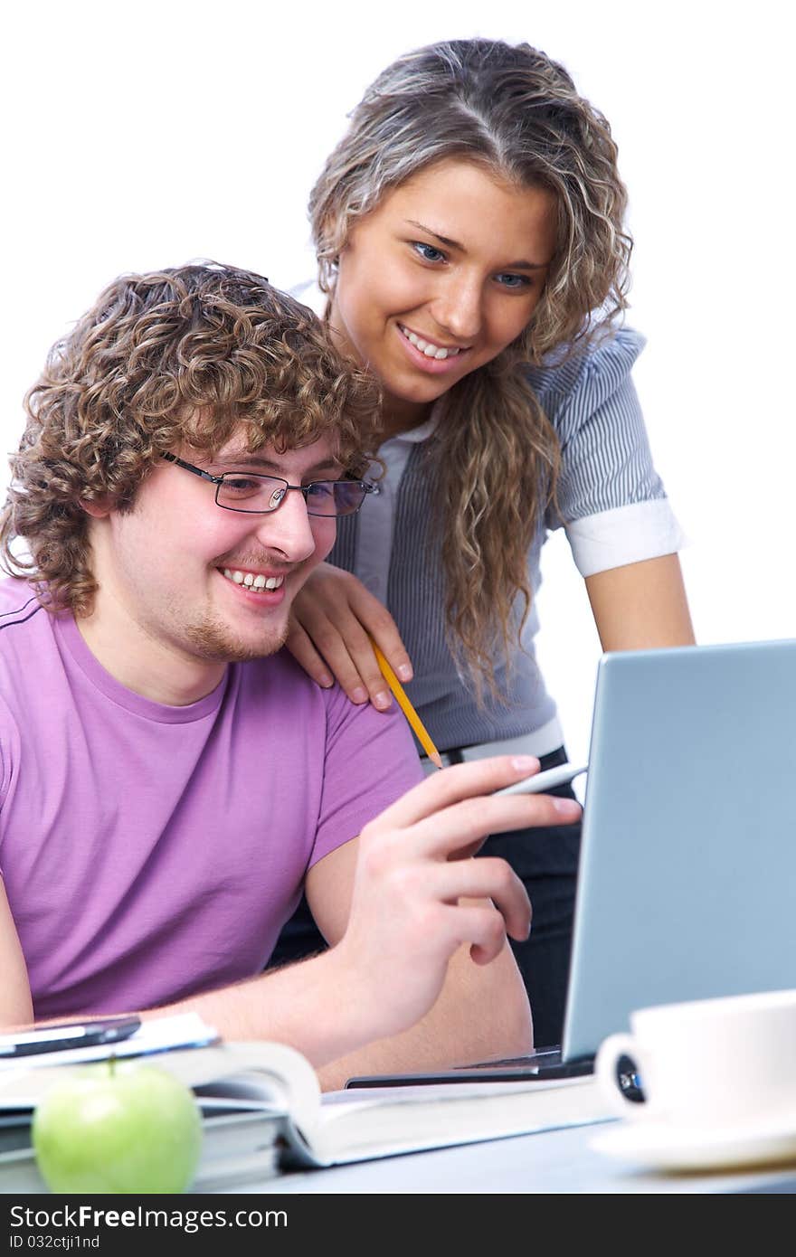 Teenage boy and girl sitting in front of a laptop and do a fun learning. Teenage boy and girl sitting in front of a laptop and do a fun learning