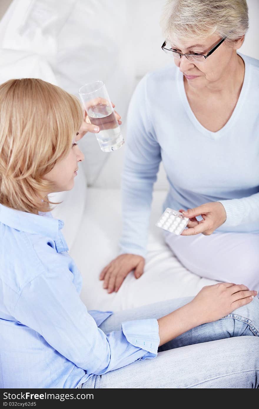 Mom gives young daughter pills. Mom gives young daughter pills