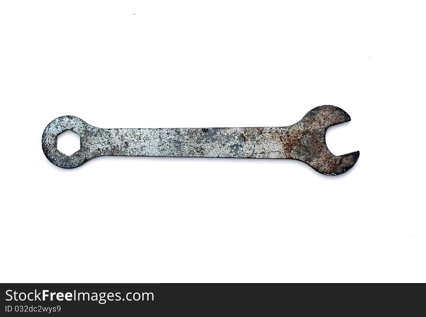 Old spanner isolated on white