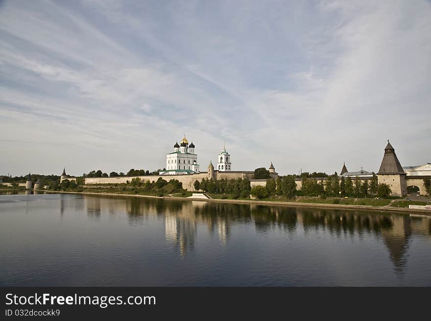 Foreshortening to the Pskov Kremlin from the bridge through the river. Foreshortening to the Pskov Kremlin from the bridge through the river