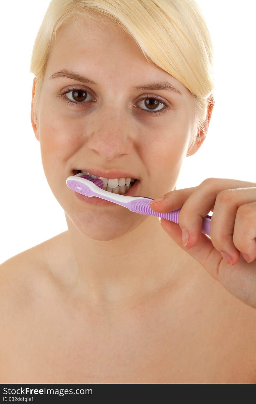 A young girl is brushing her teeths. A young girl is brushing her teeths