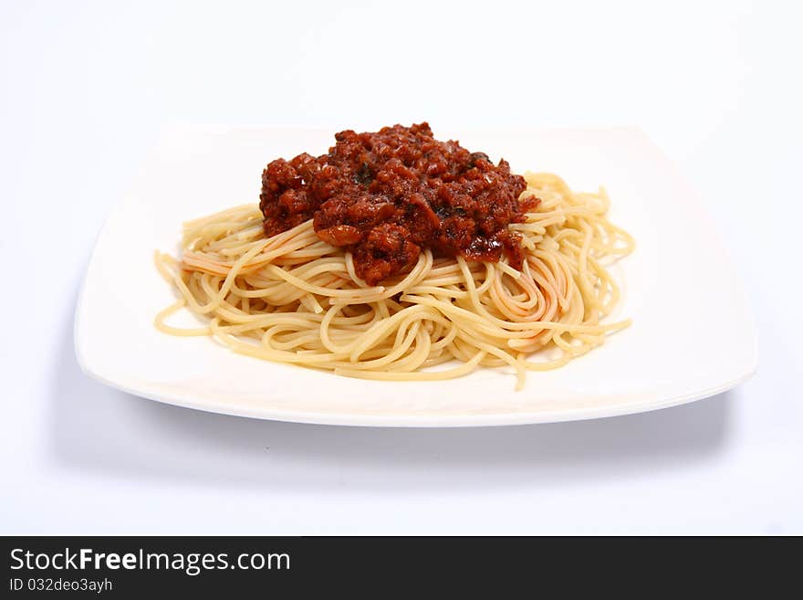 Pasta with bolognese sauce on a plate on white background