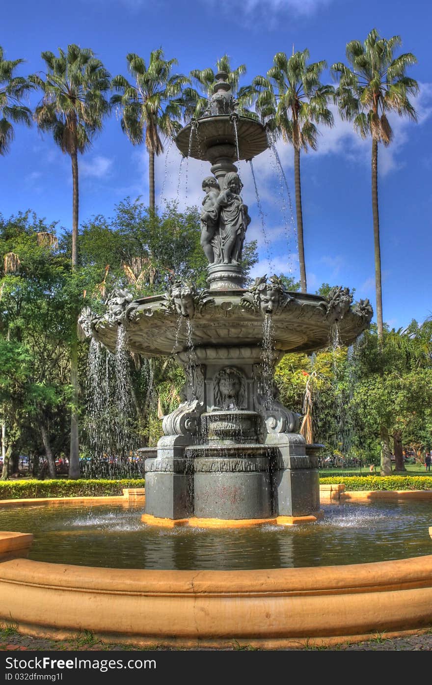 Gargoylian fountain, HDR image, high resolution. Angels, palms, sky, high depth of details and textures.