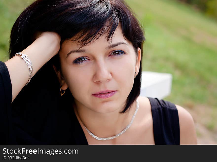 Thoughtful beautiful brunette in the nature close-ups. Thoughtful beautiful brunette in the nature close-ups