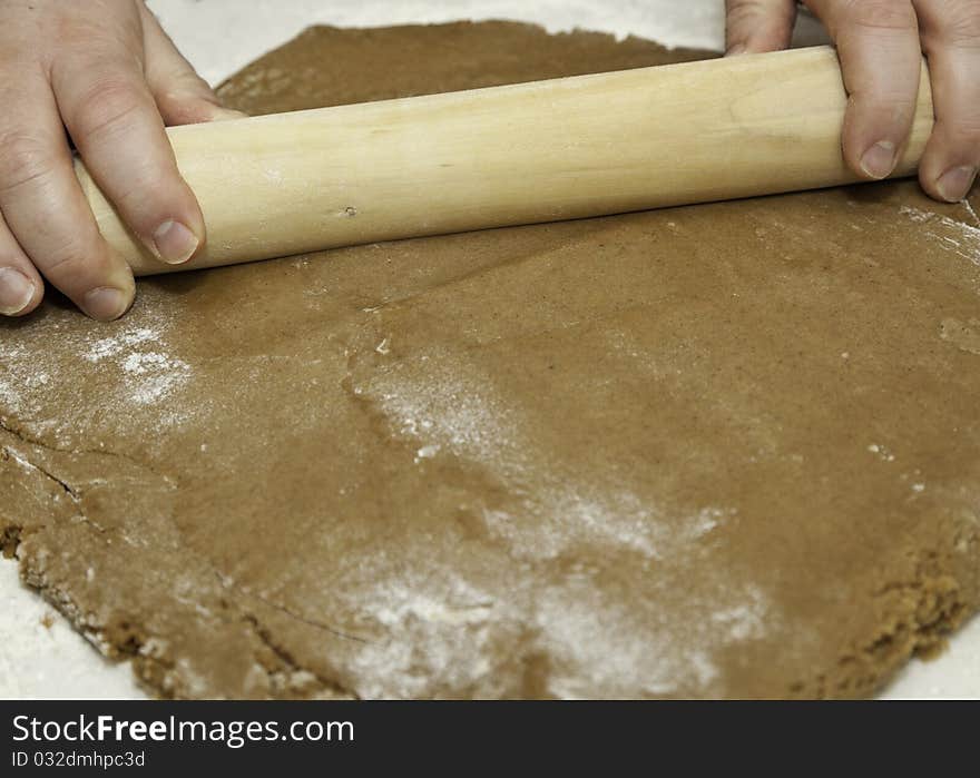 Rolling cookie dough with a wooden rolling pin