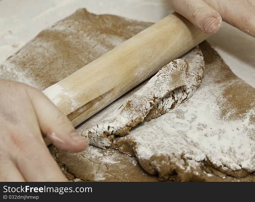 Rolling cookie dough with a wooden rolling pin