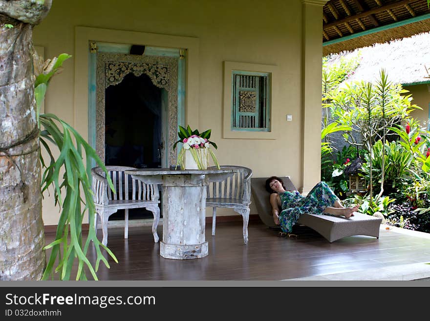 The woman having a rest on a verandah. The woman having a rest on a verandah