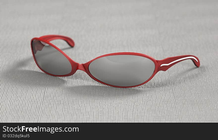 Red Shades sitting on table with silver cloth underneath.