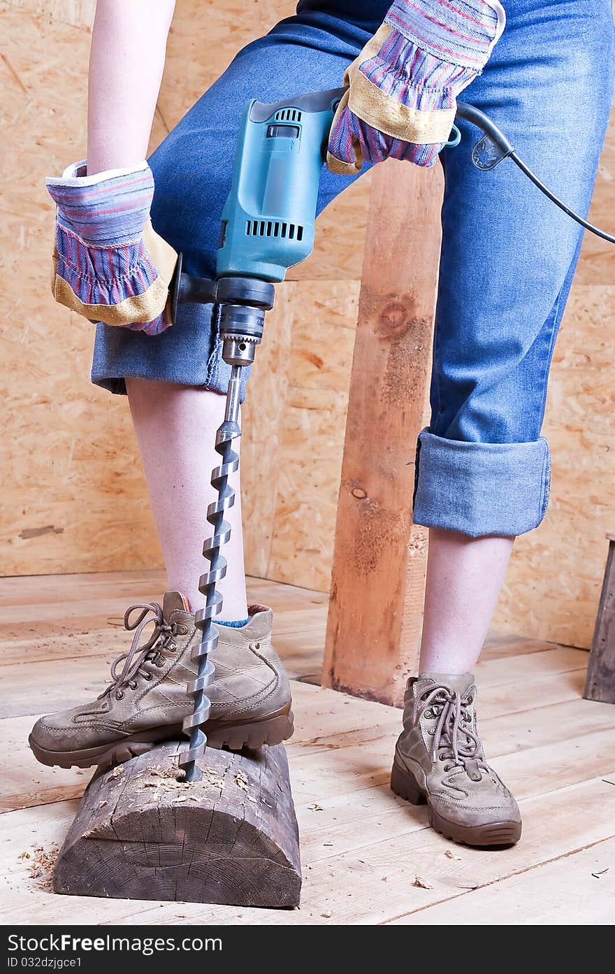 Drill and aperture in a wooden log against wooden walls