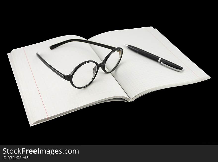 Spectacles under the notebook