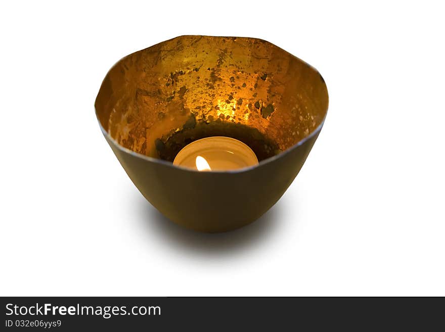 Tea candle in shiny metal cup