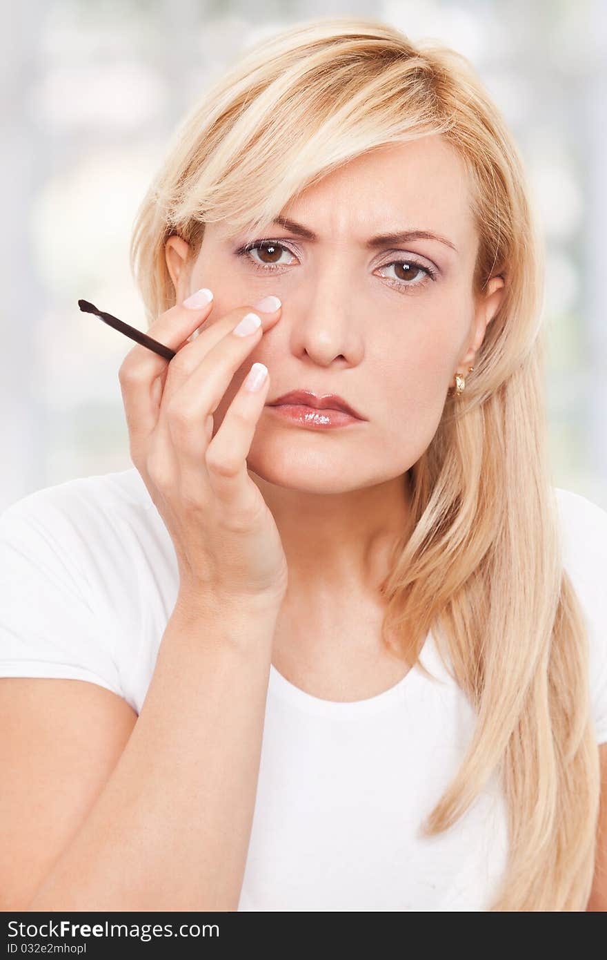 Beauty, worriyng woman making-up at home