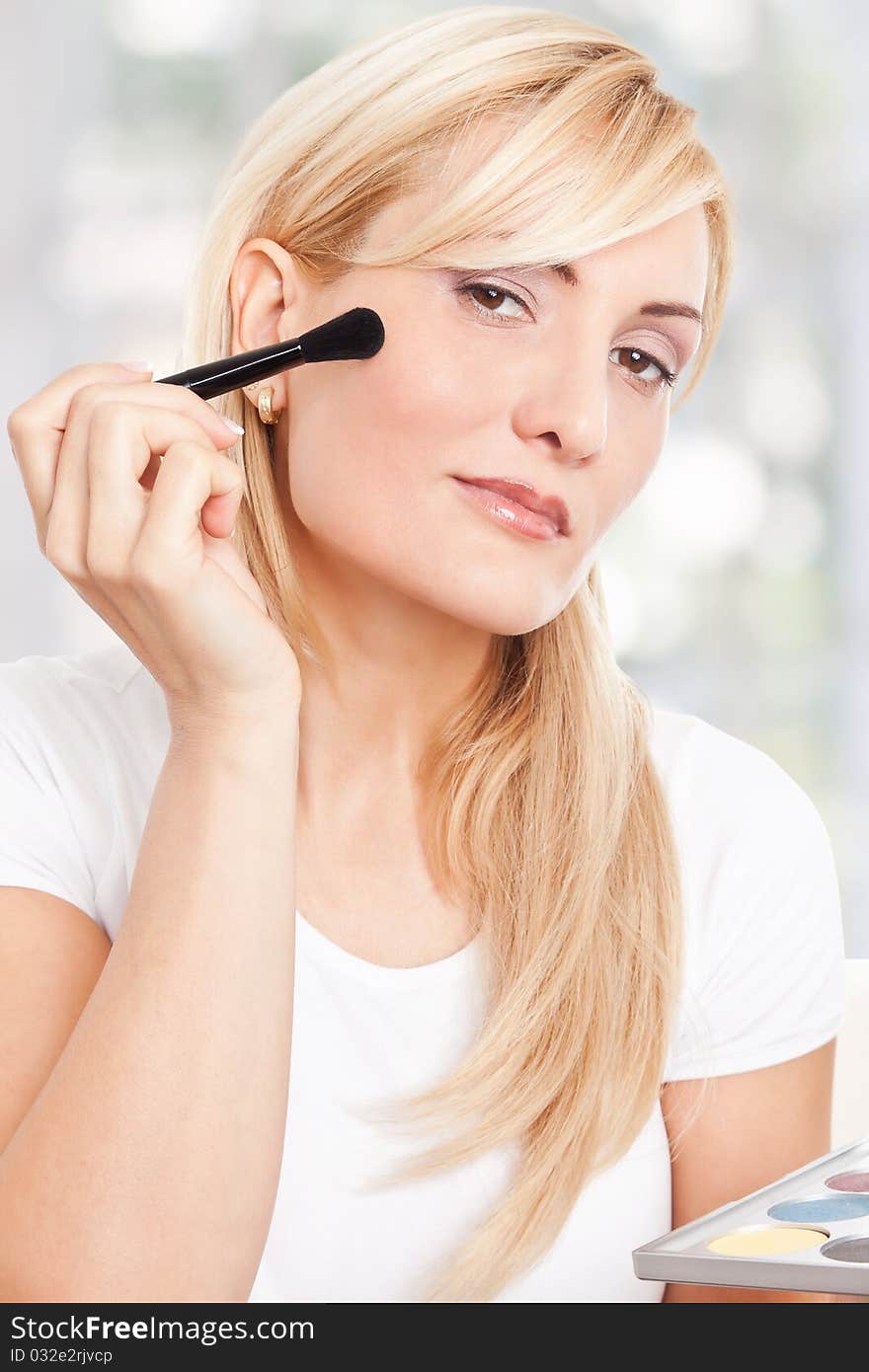 Beauty woman making-up and smiling