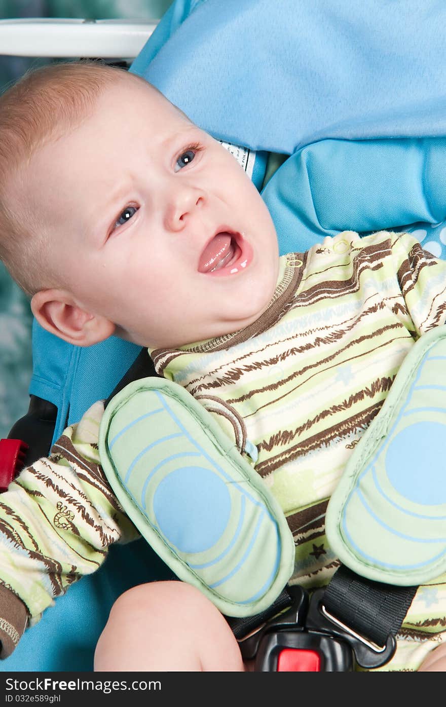 To the child seven months, he sits in a children's automobile armchair. To the child seven months, he sits in a children's automobile armchair.