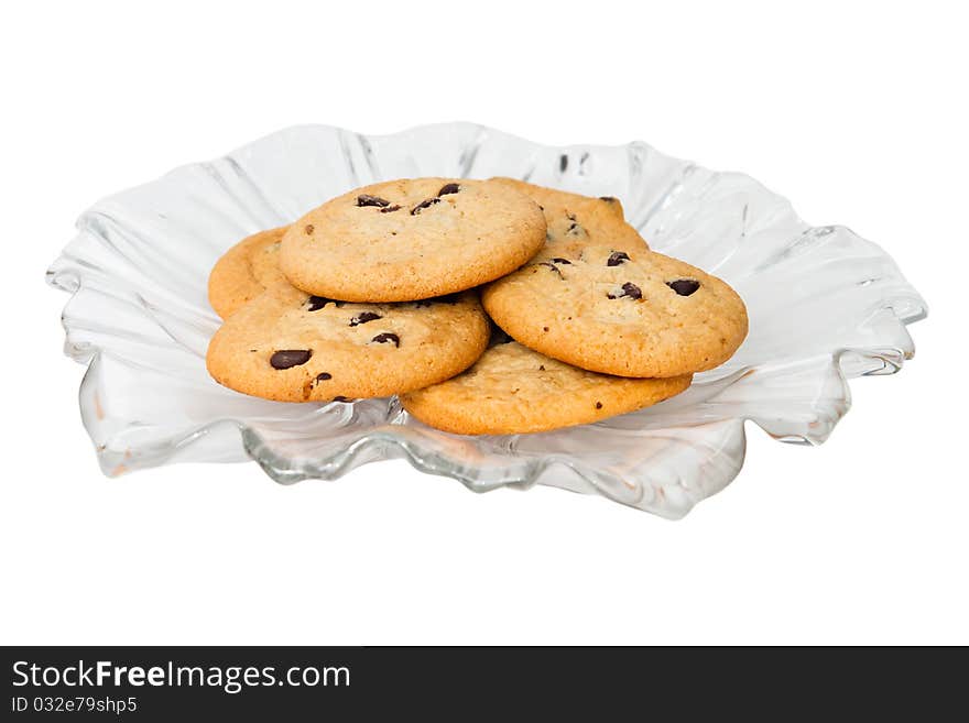 A selection of chocolate chip cookies on a decorative glass plate.