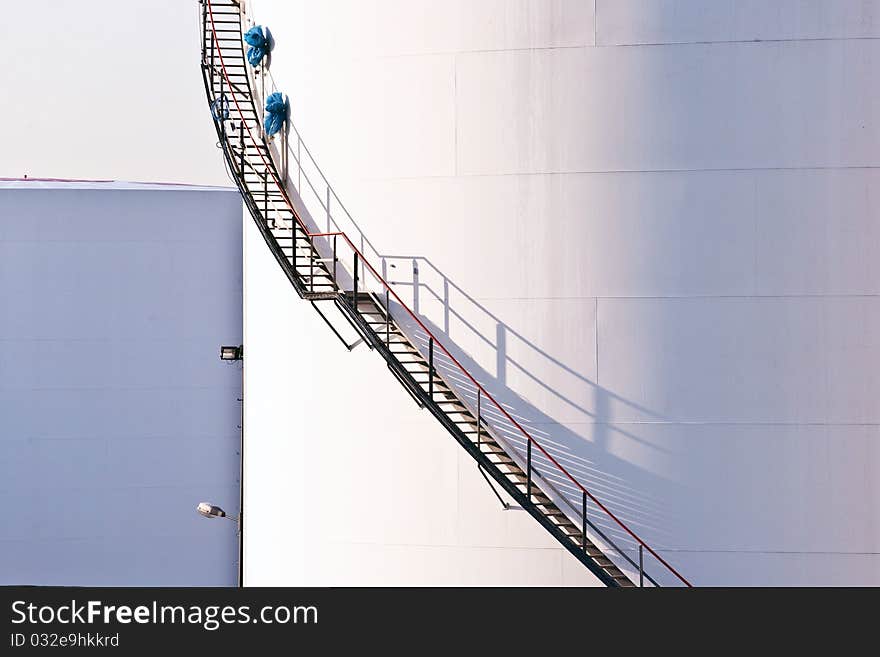 White tanks in tank farm with blue sky