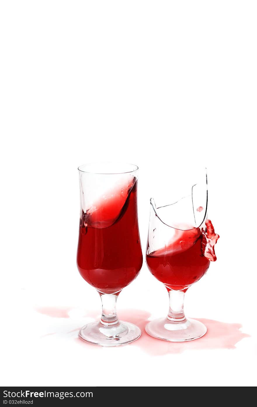 Two glasses with wine and drops ,isolated on white background .one  glass is broken. Two glasses with wine and drops ,isolated on white background .one  glass is broken