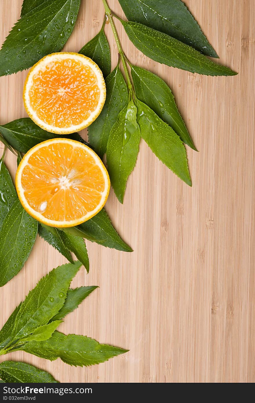 Orange with leaves on the wood background