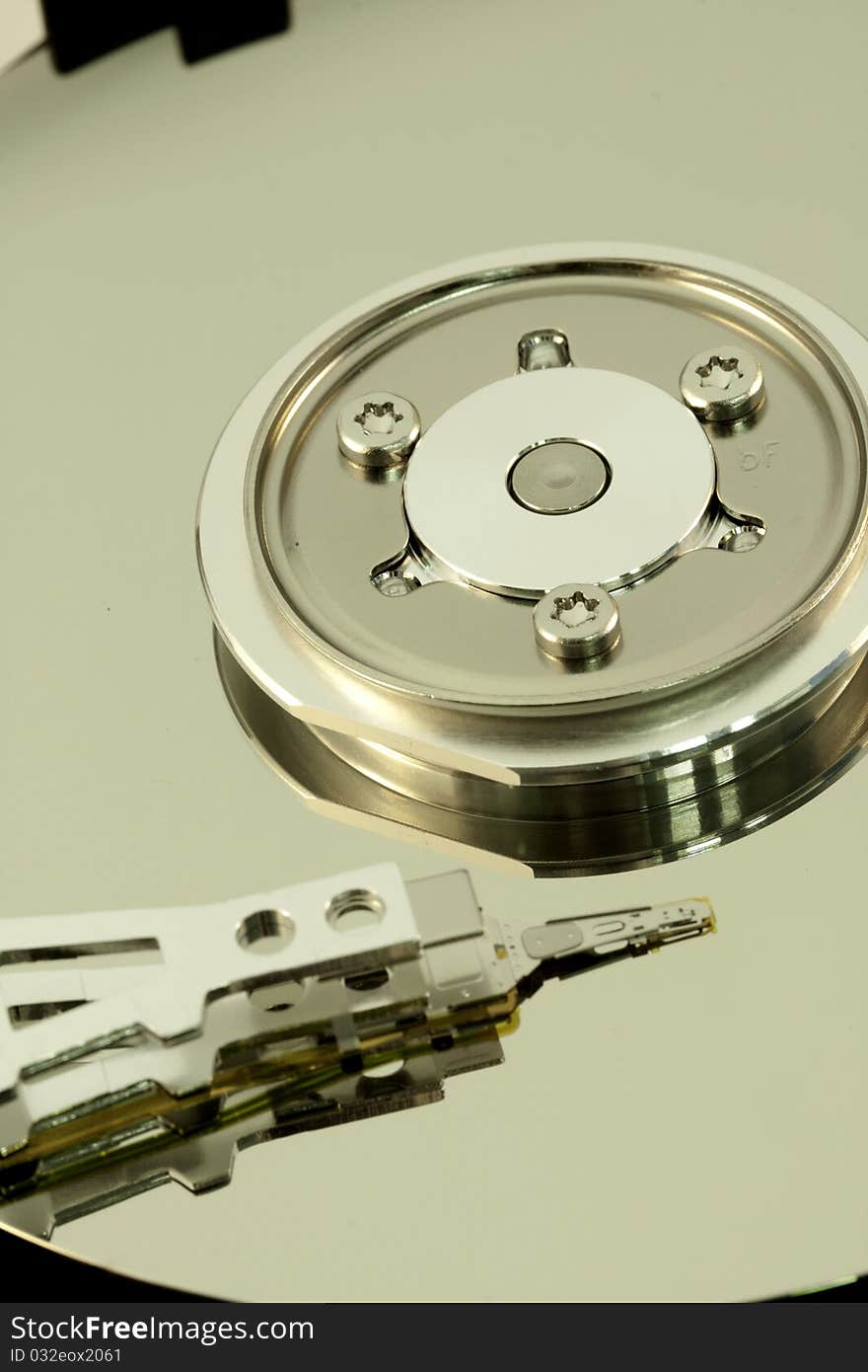 Close view detail of the inside of a computer harddisk isolated on a white background. Close view detail of the inside of a computer harddisk isolated on a white background.