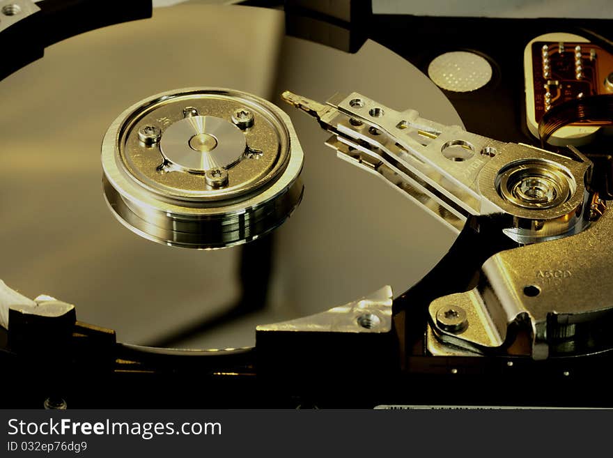 Close view detail of the inside of a computer harddisk isolated on a white background. Close view detail of the inside of a computer harddisk isolated on a white background.