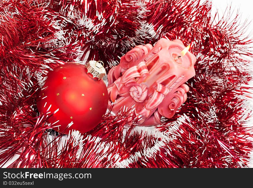 Candle burning and new-year red ball with a shower. Candle burning and new-year red ball with a shower