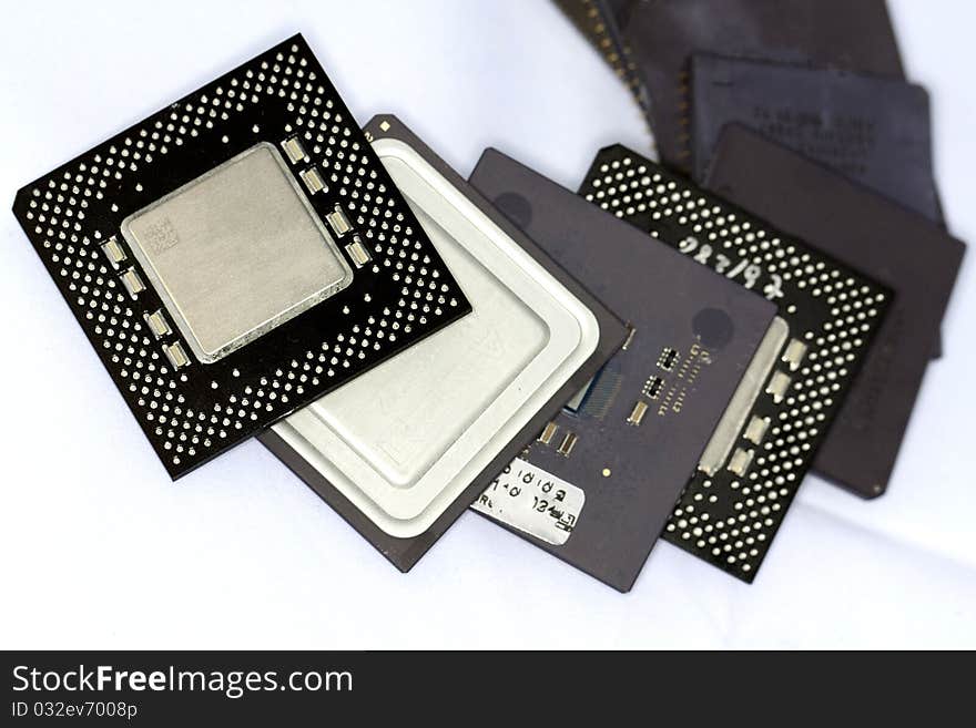 Close view detail of some computer microprocessors isolated on a white background.