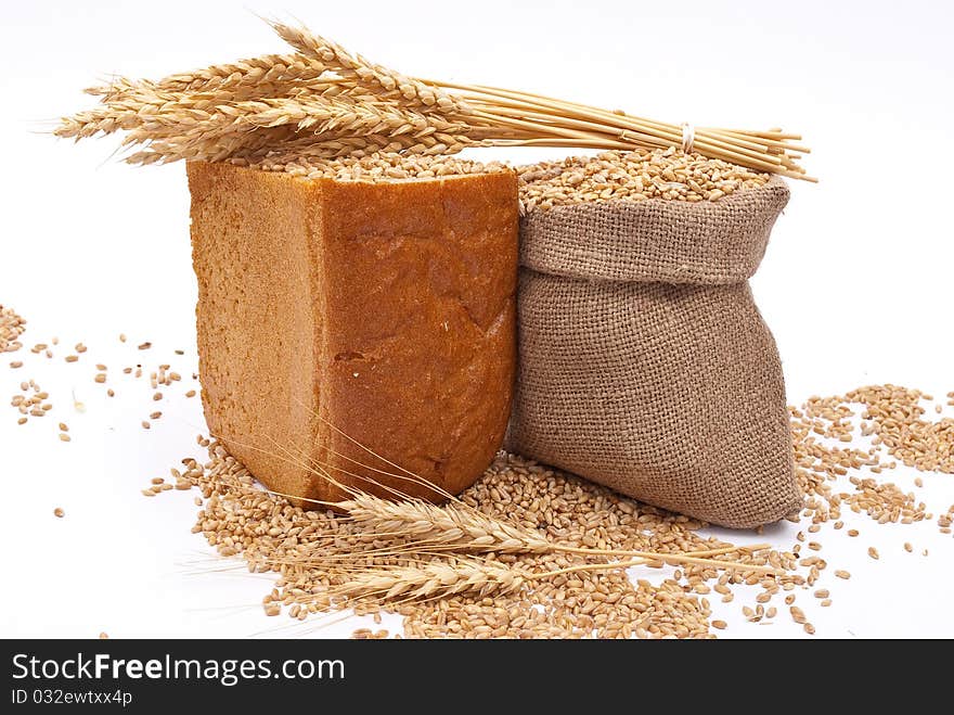 Bread with wheat and ears on white