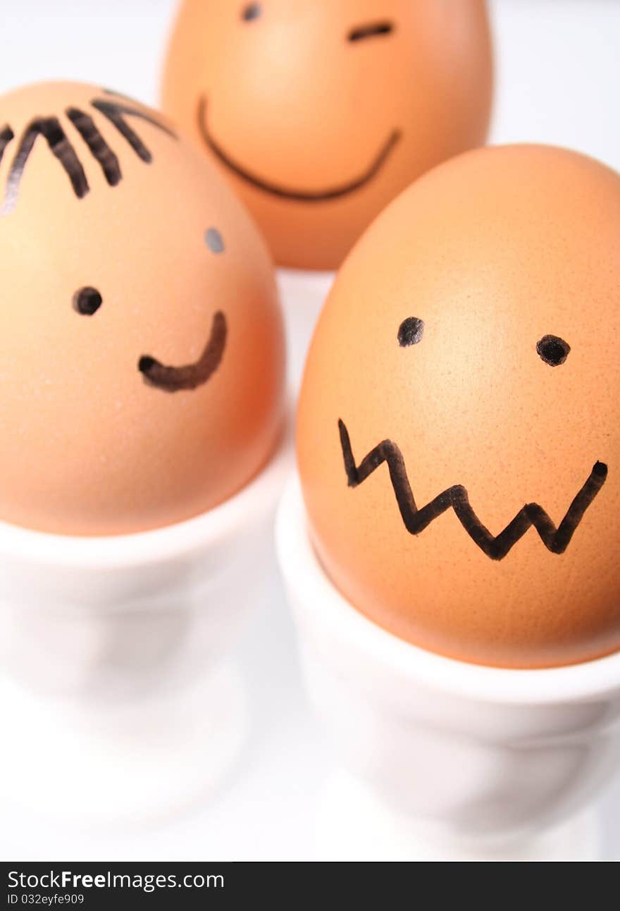 Eggs with a smiling faces on white background