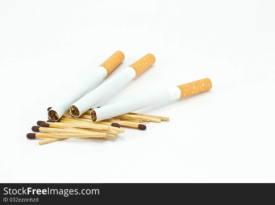 Cigarette and matches on white