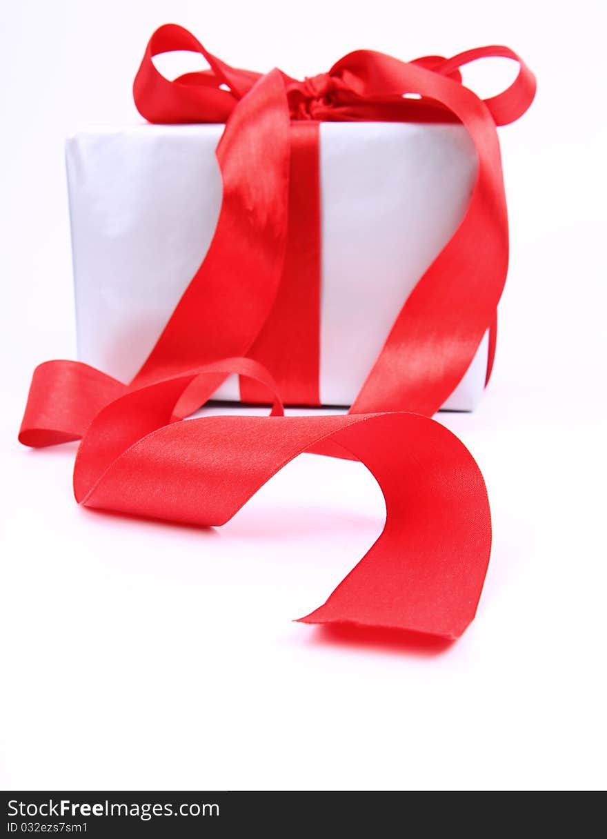 Gift in silver wrapping with red bow