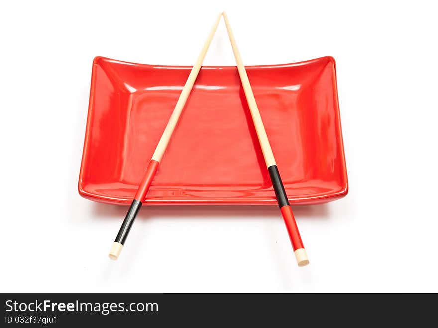 Black and red sushi set (chopsticks and plate) isolated on white background