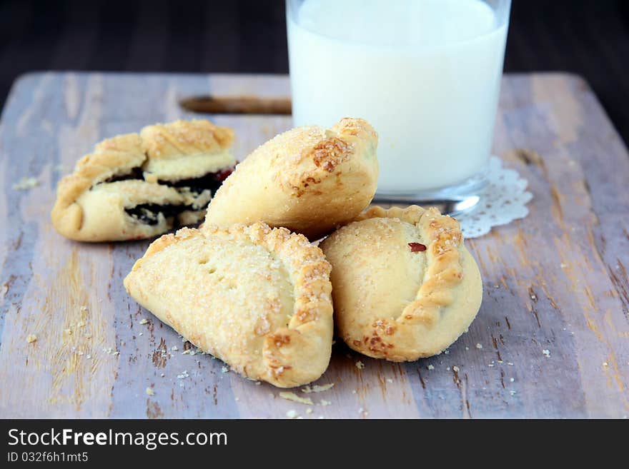 Buns with milk on a wooden board