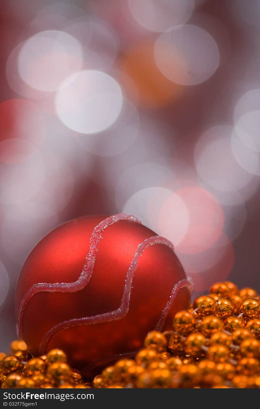 Red globe on top of golden marbles as decoration for christmas.