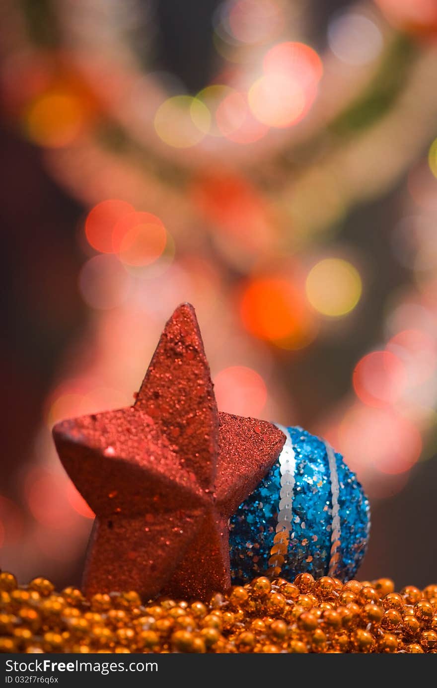 Red star and blue globe as christmas decoration on top of golden beaded garland