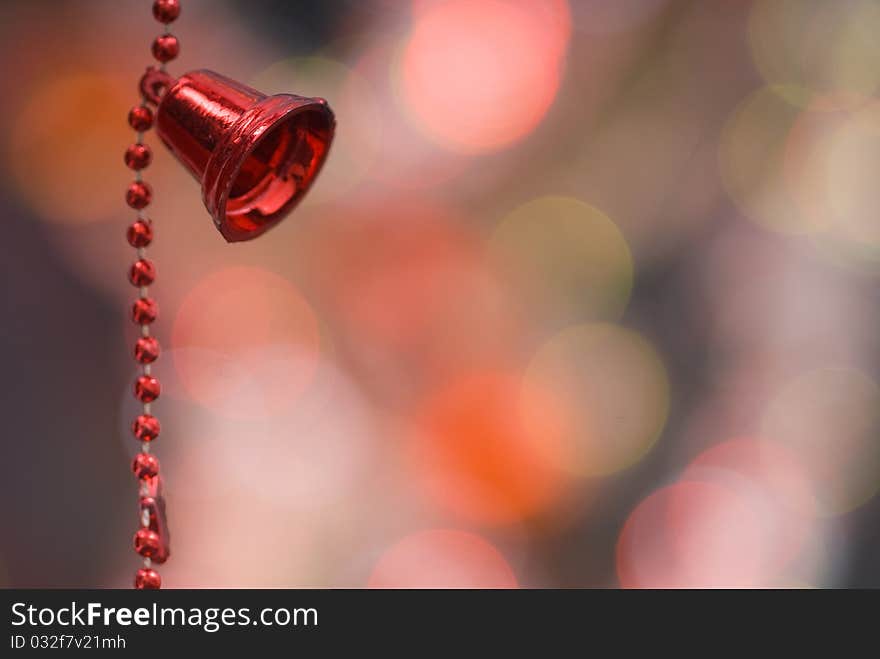 Christmas decoration with red bells and red beaded garland