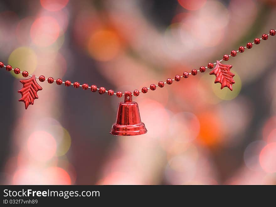 Christmas decoration with red bells and red beaded garland