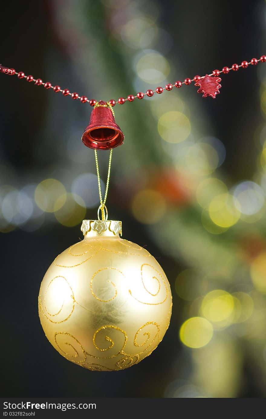 Christmas decoration with golden globe and red beaded garland