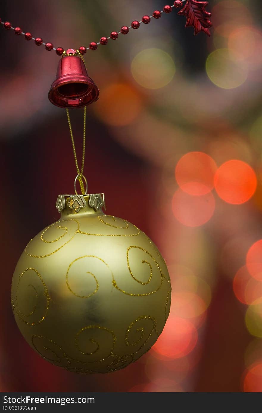 Christmas decoration with golden globe and red beaded garland