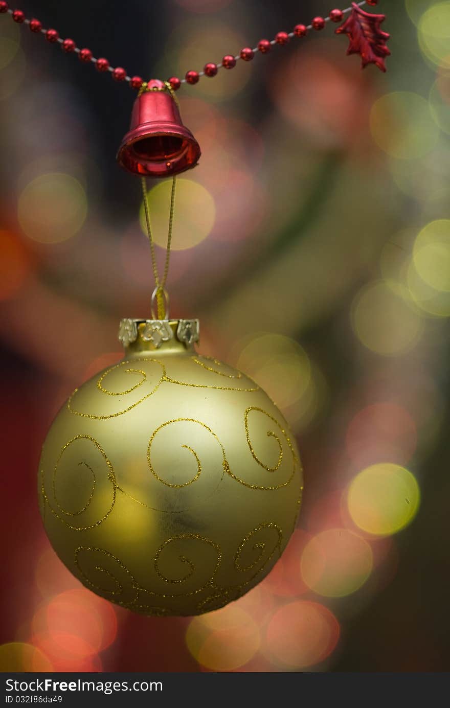 Christmas decoration with golden globe and red beaded garland