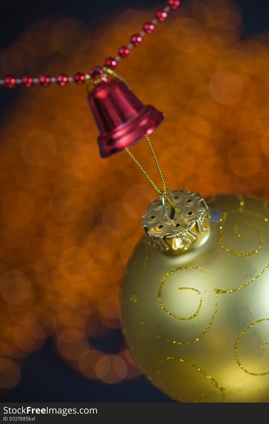 Christmas decoration with golden globe and red beaded garland