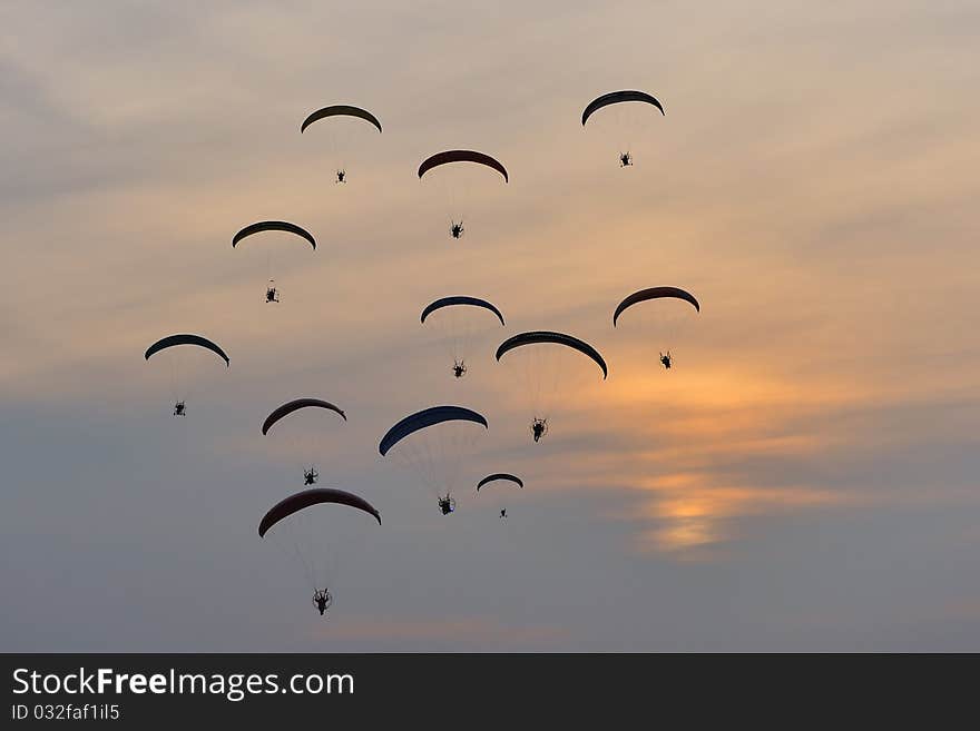 Group of paramotors flying at sunset. Group of paramotors flying at sunset