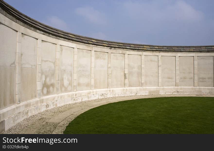 A curved white memorial wall bearing the names of soldiers who died in the first world war in Europe. A curved white memorial wall bearing the names of soldiers who died in the first world war in Europe