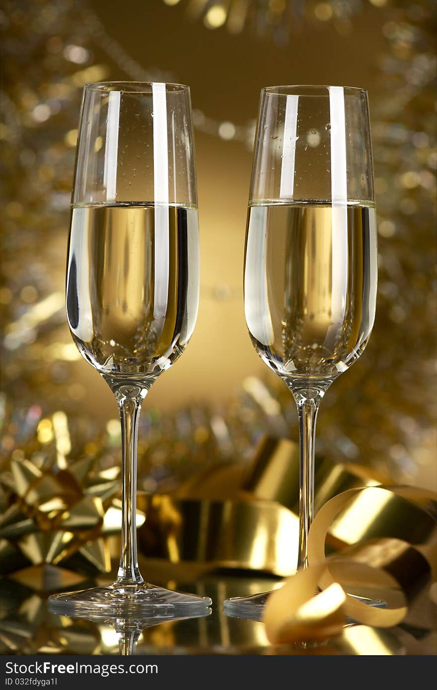 Champagne in glasses on a yellow background. Champagne in glasses on a yellow background