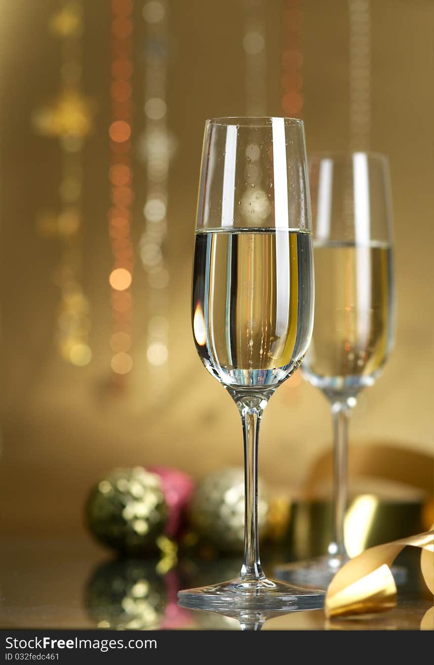 Champagne in glasses on a yellow background. Champagne in glasses on a yellow background