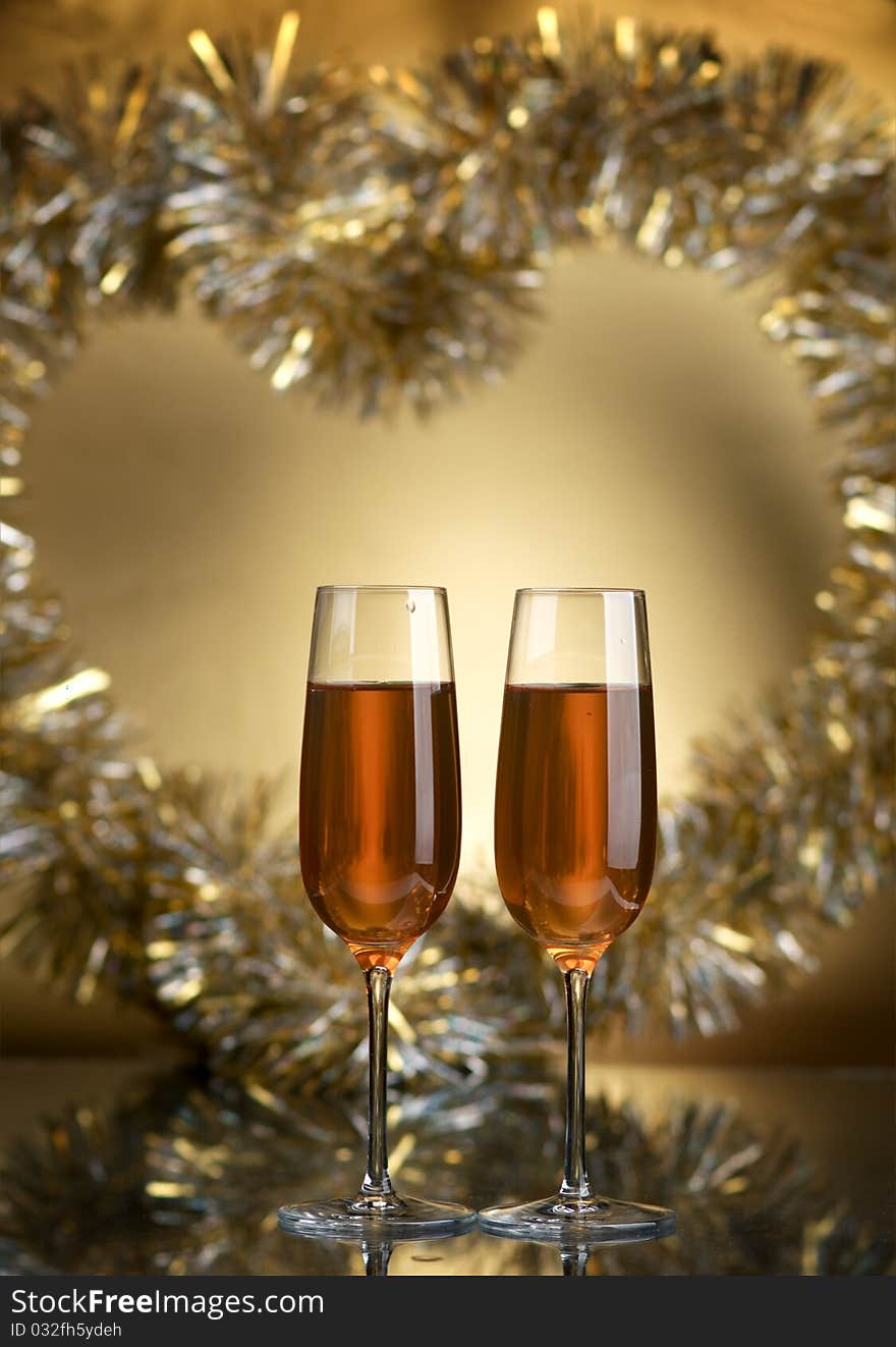 Champagne in glasses on a yellow background. Champagne in glasses on a yellow background