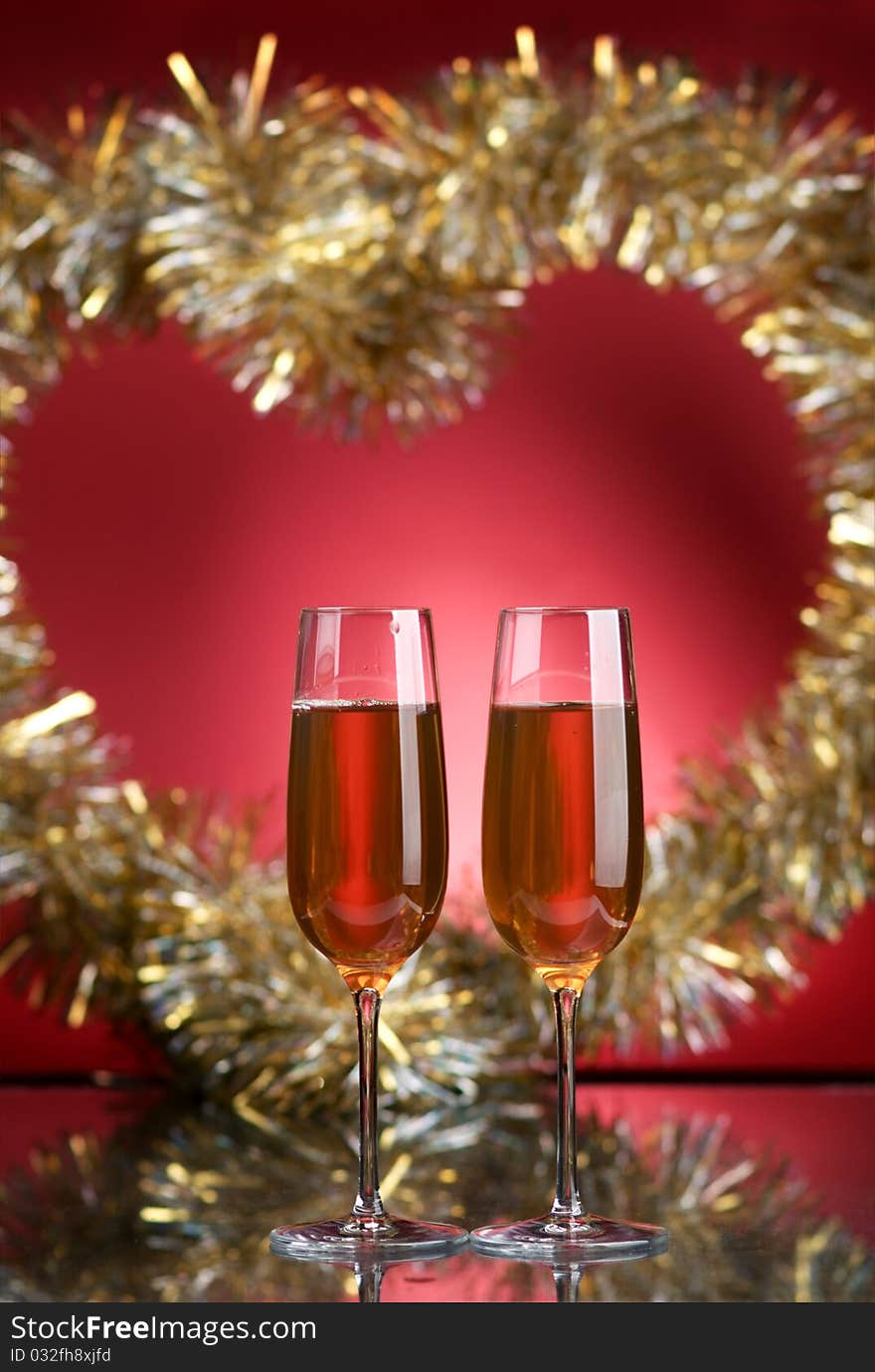 Champagne in glasses on a red background. Champagne in glasses on a red background