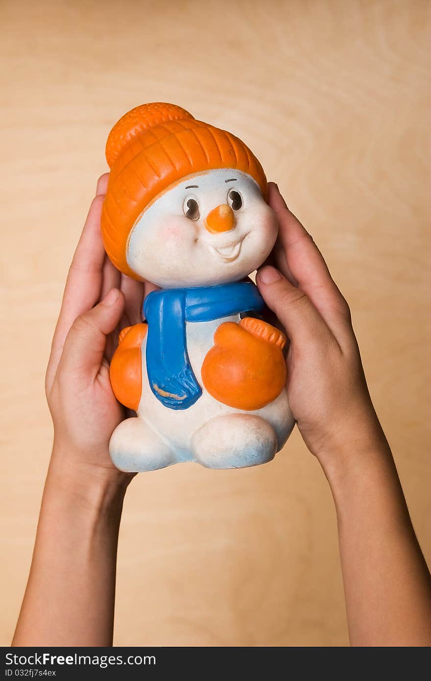 Toy snow man on the hands of child. Toy snow man on the hands of child