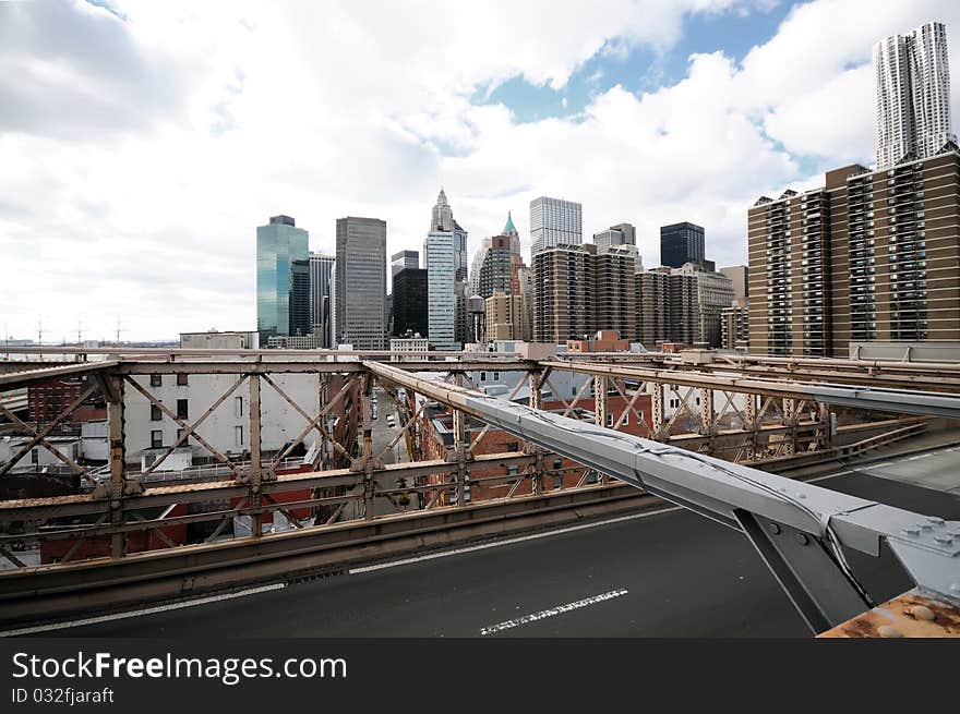 New York City Brooklyn Bridge in Manhattan closeup with skyscrapers and city skyline over Hudson River.