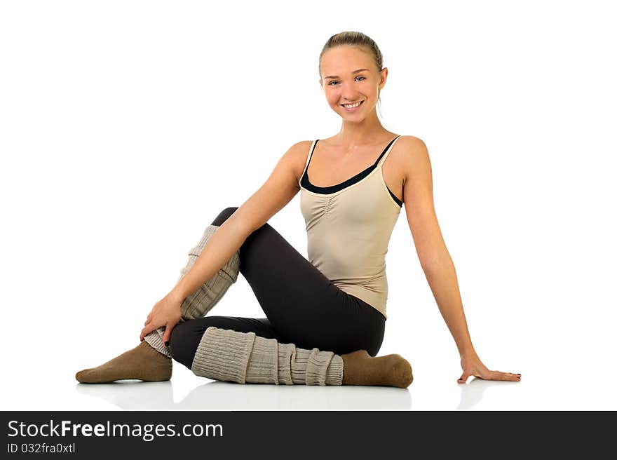 Portrait of smiling young girl practicing yoga on isolated white background