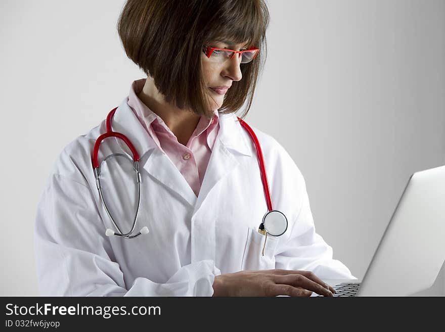 Portrait of a female doctor with laptop